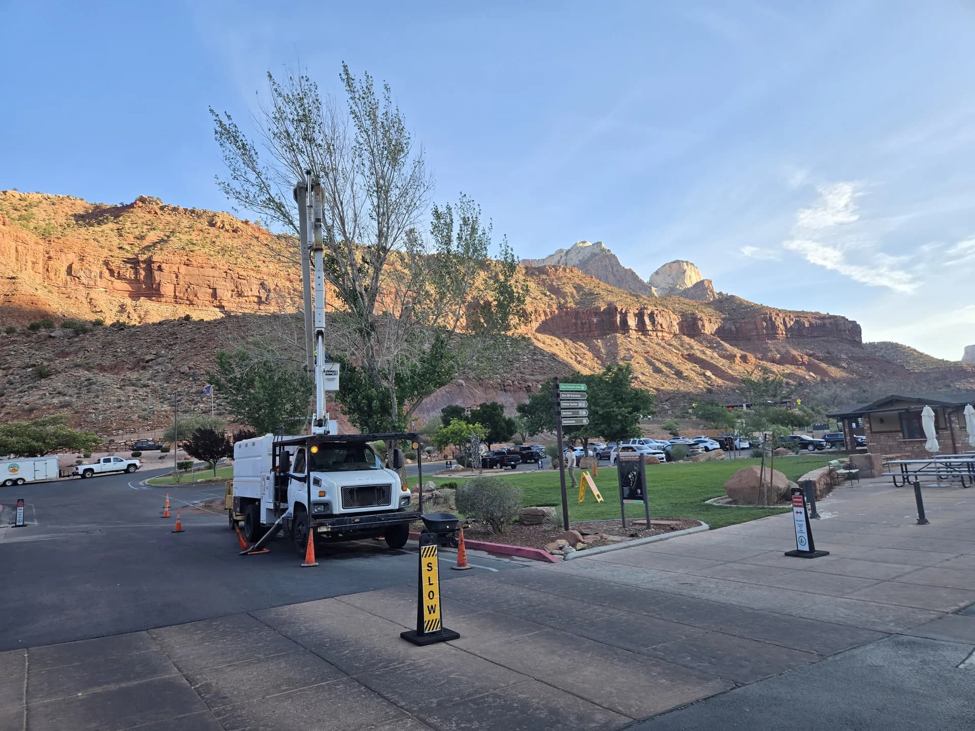 Bucket truck set up on a street job with red rock mesas behind